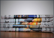 Stack of folded newspapers on a table